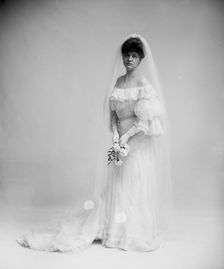 Woman in wedding dress holding flowers, between 1900 and 1910. Creator: Unknown