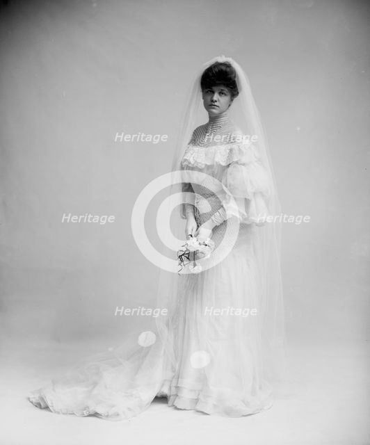 Woman in wedding dress holding flowers, between 1900 and 1910. Creator: Unknown.