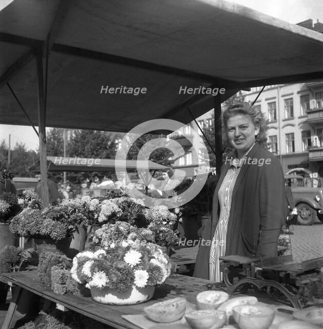 Woman on her flower stall in the market, Malmö, Sweden, 1947. Artist: Otto Ohm