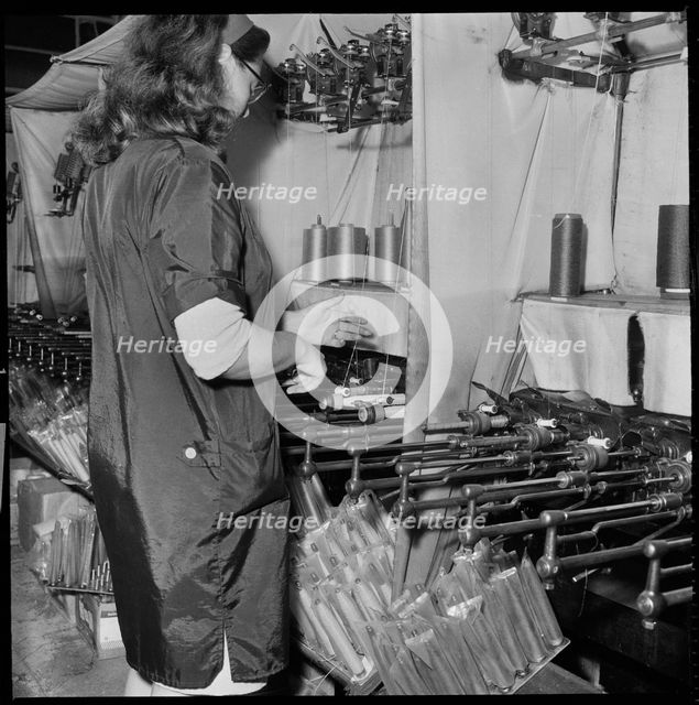 Woman operating a cop winding frame in a textile mill, 1966-1974. Creator: Eileen Deste.