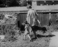 Woman Leading Her Children to an Air Raid Shelter, 1940. Creator: British Pathe Ltd