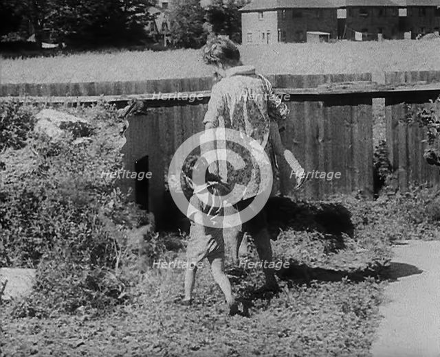 Woman Leading Her Children to an Air Raid Shelter, 1940. Creator: British Pathe Ltd.