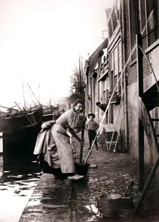 Woman mopping the street, Dordrecht, Netherlands, 1898.Artist: James Batkin