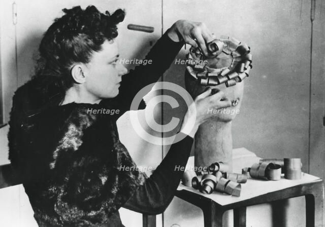 Woman making a hat from wood shavings, German-occupied France, April 1941. Artist: Unknown