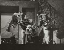 Woman smiling, surrounded by three men, 1938. Creator: Unknown