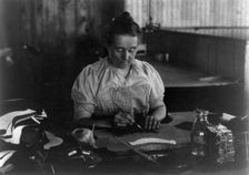 Woman seated at a table, working in a shoe factory, Lynn, Mass., (1895?). Creator: Frances Benjamin Johnston