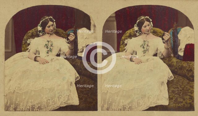 Woman seated in enlongated chair admiring herself in a hand mirror, about 1865. Creator: London Stereoscopic & Photographic Co.