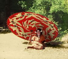 Woman sitting under a parasol, between 1905 and 1915. Creator: Sergey Mikhaylovich Prokudin-Gorsky