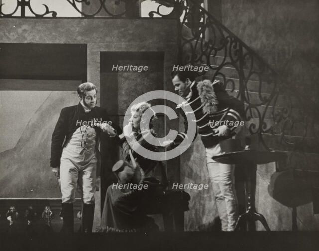 Woman sitting and two men standing, 1938. Creator: Unknown.