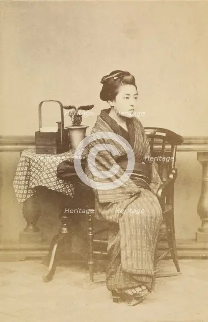 Woman sitting by table, about 1868. Creator: Felice Beato.