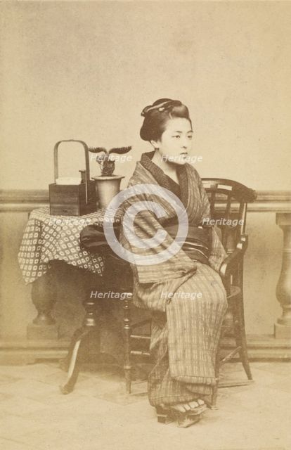 Woman sitting by table, about 1868. Creator: Felice Beato.