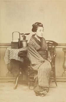 Woman sitting by table, about 1868. Creator: Felice Beato