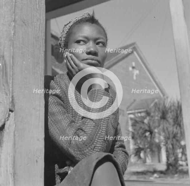 Woman sitting on her porch on Sunday morning, Daytona Beach, Florida, 1943. Creator: Gordon Parks.