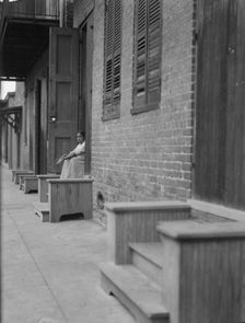 Woman sitting on steps, New Orleans or Charleston, South Carolina, between 1920 and 1926. Creator: Arnold Genthe