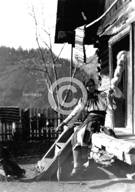 Woman spinning wool, Bistrita Valley, Moldavia, north-east Romania, c1920-c1945. Artist: Adolph Chevalier