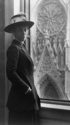 Woman standing by window, 3/4 lgth., facing slightly right, overlooking cathedral door, n.d.. Creator: Frances Benjamin Johnston
