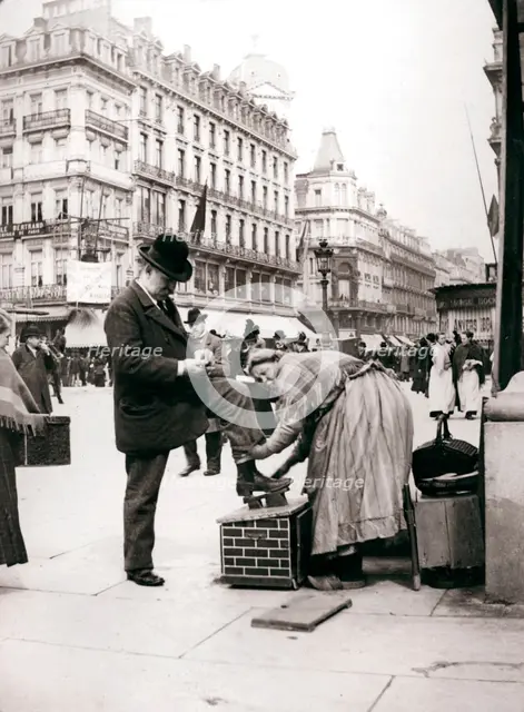 Woman polishing shoes, Brussels, 1898.Artist: James Batkin