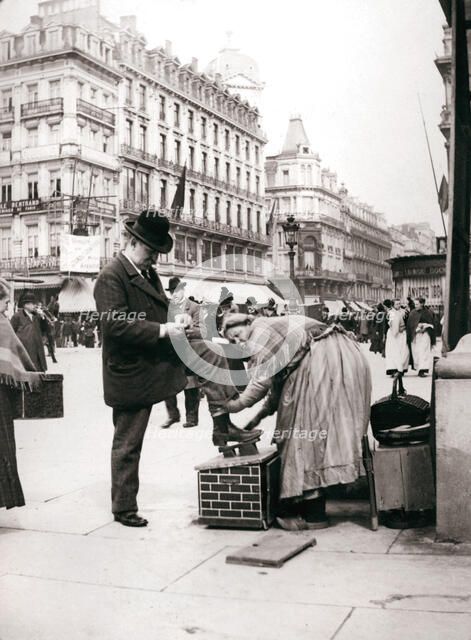 Woman polishing shoes, Brussels, 1898.Artist: James Batkin
