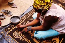 Woman painting with mud from the River Niger, Djenné, Mali, 1990. Creator: Amanda Waite