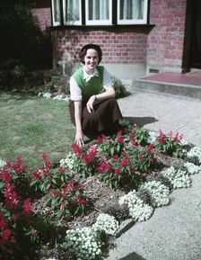 Woman proudly showing off her flower bed, c1955. Creator: Arthur Charles Kirby Ware