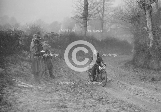 Woman riding a Royal Enfield motorcycle in the Gloucester Trial, c1930s. Artist: Bill Brunell.