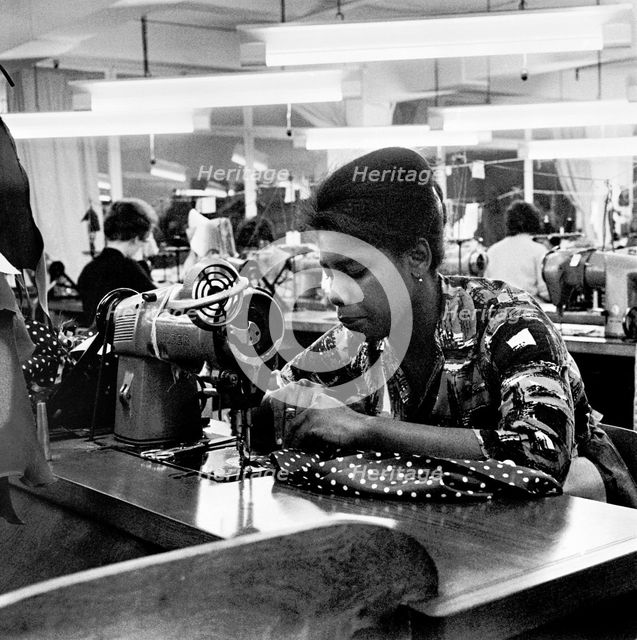 Woman working at a sewing machine, London, (c1955-c1975?). Creator: Henry Grant.