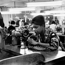 Woman working at a sewing machine, London, (c1955-c1975?). Creator: Henry Grant