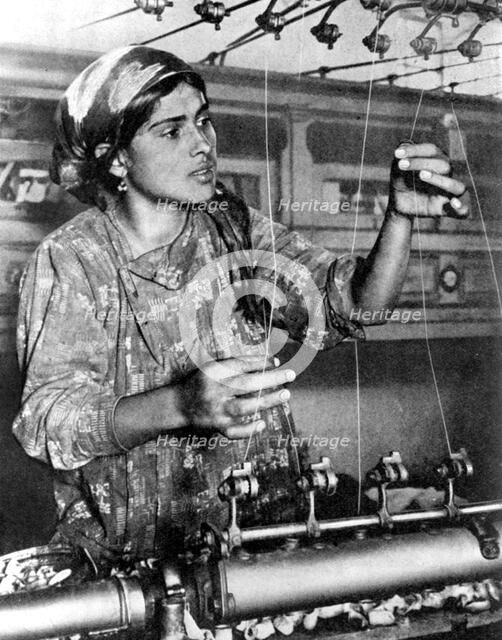 Woman working in the silk industry, Samarkand, Uzbekistan, 1936. Artist: Unknown