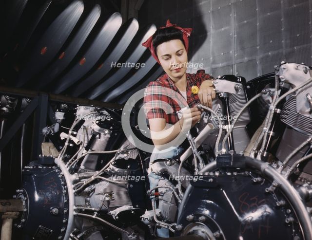 Woman working on an airplane motor at North American Aviation, Inc., plant in Calif., 1942. Creator: Alfred T Palmer.