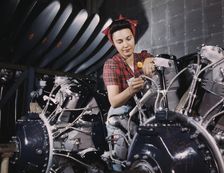 Woman working on an airplane motor at North American Aviation, Inc., plant in Calif., 1942. Creator: Alfred T Palmer