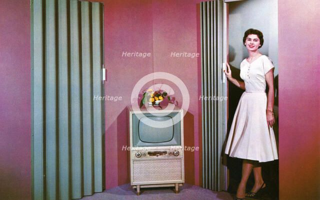 Woman walking into a room with a television, Janesville, Wisconsin, USA, 1955. Artist: Unknown