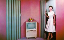 Woman walking into a room with a television, Janesville, Wisconsin, USA, 1955