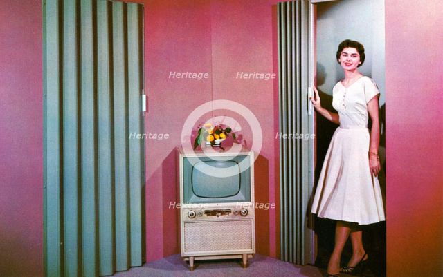 Woman walking into a room with a television, Janesville, Wisconsin, USA, 1955. Artist: Unknown