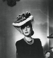 Woman wearing a hat and veil by the French fashion designer Jacques Fath, France, 1943