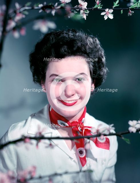 Woman wearing a red neck scarf, c1955.  Creator: Arthur Charles Kirby Ware.