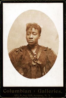 Woman wearing dress covered with lace across the bodice, c1890-c1899. Creator: Columbian Galleries