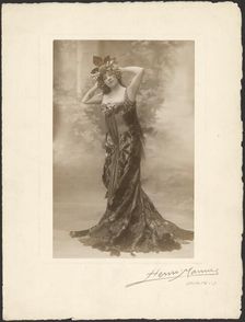 Woman wearing headdress with grapes, about 1890. Creator: Henri Mannes