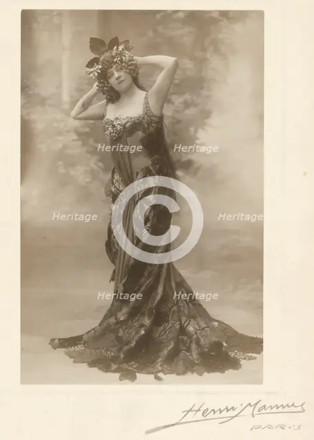 Woman wearing headdress with grapes, about 1890. Creator: Henri Mannes.