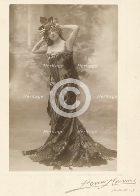 Woman wearing headdress with grapes, about 1890. Creator: Henri Mannes.