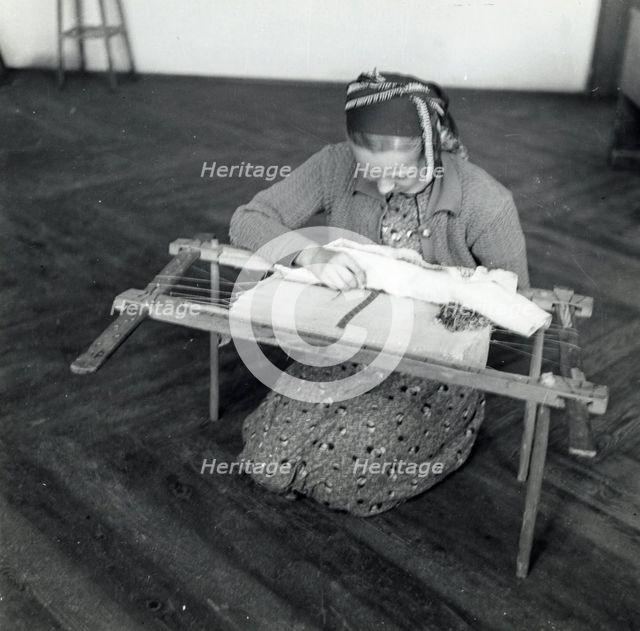 Woman weaving, Sarajevo, Bosnia-Hercegovina, Yugoslavia, 1939. Creator: Unknown.