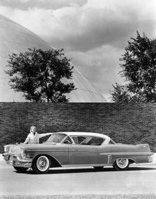 Woman with a 1957 Cadillac coupe de ville, (c1957?)