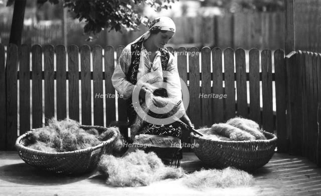 Woman with baskets of wool, Bistrita Valley, Moldavia, north-east Romania, c1920-c1945. Artist: Adolph Chevalier