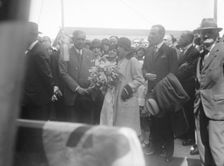 Woman with bouquet, c1935. Creator: Kirk & Sons of Cowes