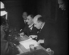 Woman Talking to Four Men Sitting at a Desk, 1933. Creator: British Pathe Ltd