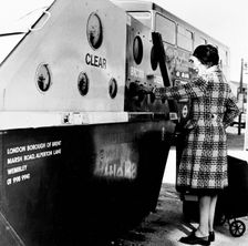 Woman using a bottle bank in Brent, London, c1950s. Creator: Henry Grant