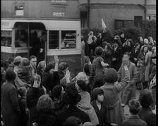 Women, Children, and Men Waving Goodbye to Children Being Evacuated by Bus, 1939. Creator: British Pathe Ltd