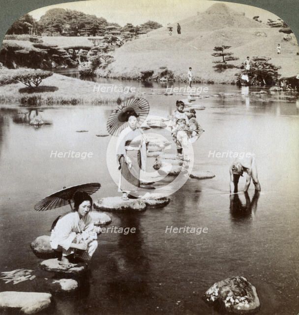 Women crossing the lake on stepping stones, Suizen-ji Garden, Kumamoto, Japan, 1904.Artist: Underwood & Underwood
