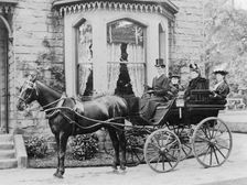 Women and a coachman in a pony and trap, late 19th century