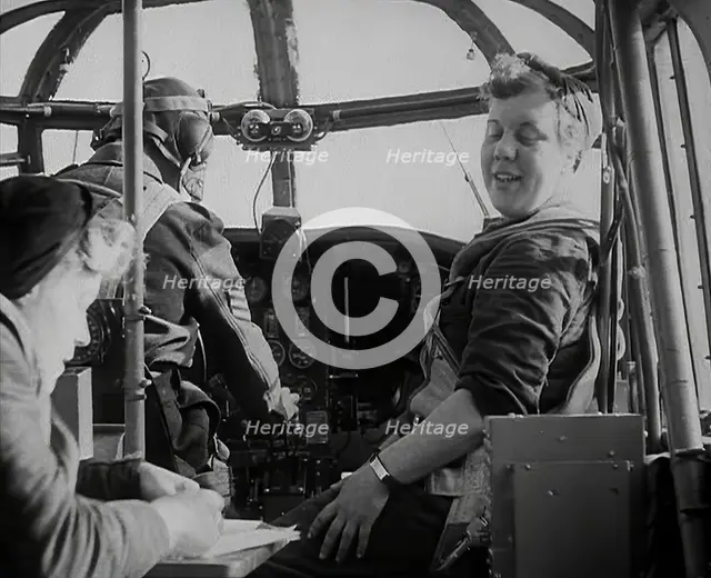 Women and a Pilot Sitting in the Cockpit of a Plane, 1942. Creator: British Pathe Ltd.