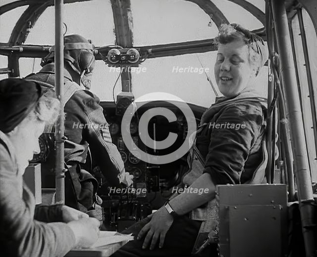 Women and a Pilot Sitting in the Cockpit of a Plane, 1942. Creator: British Pathe Ltd.